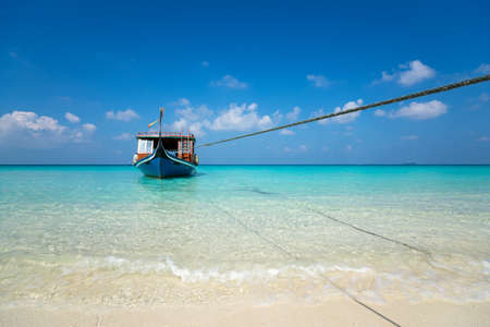 Perfect tropical island paradise beach and old boatの写真素材