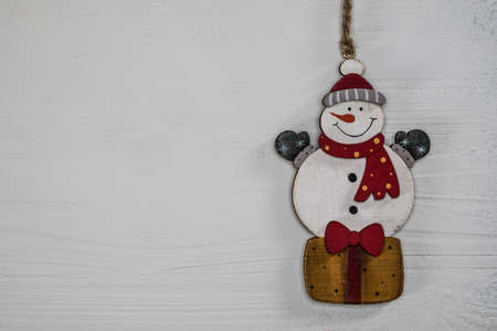 Toy snowman Christmas decoration. Vintage style, white background, with copy space for your text.の写真素材