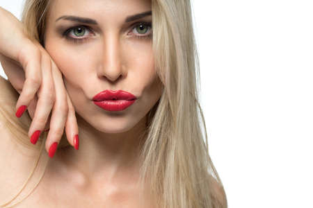 Close-up portrait of sexy woman lips with red lipstick and red manicureの写真素材