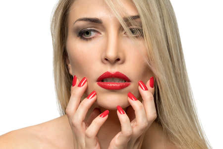 Close-up portrait of sexy woman lips with red lipstick and red manicureの写真素材