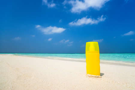 Sunscreen cream bottle on the beachの写真素材