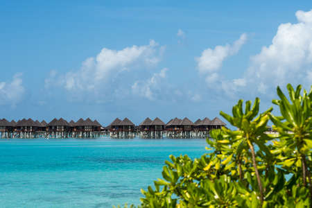 Beautiful beach with water bungalows at Maldivesの写真素材
