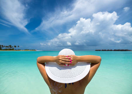 woman in hat on the beachの写真素材