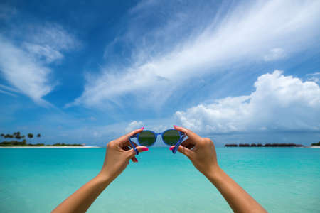 Picture of sunglasses on the tropical beach, vacation. Traveller dreams conceptの写真素材