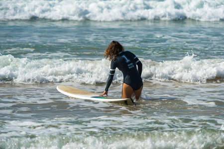 WELIGAMA, SRI LANKA - JANUARY 09 2017: Unidentified woman surfing on a large wave on Weligama beach on the coast of Indian ocean  - is the best surf paradise in Sri Lankaのeditorial素材