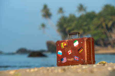 Travel  vintage suitcase is alone on a beachの写真素材