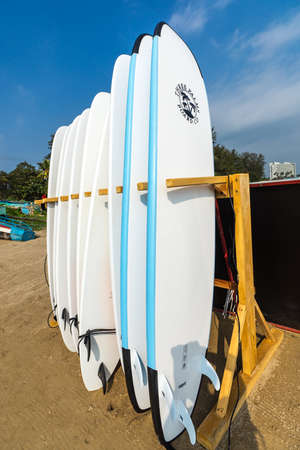 WELIGAMA, SRI LANKA - JANUARY 12 2017: Set of different color surf boards in a stack by ocean.WELIGAMA, SRI LANKA. Surf boards on sandy Weligama beach. On Weligama beach surf is available all year around for beginner and advanced.のeditorial素材