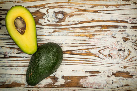 Fresh avocado isolated on wood table background. Tasty and health vegetable.の写真素材