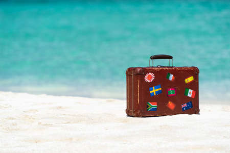 Travel  vintage suitcase is alone on a beachの写真素材
