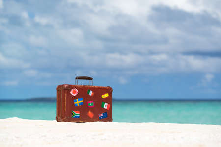 Travel  vintage suitcase is alone on a beachの写真素材