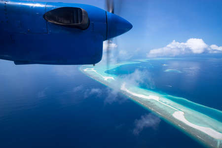 Aerial View from seaplane window over Atolls at Indian Ocean Maldivesの写真素材