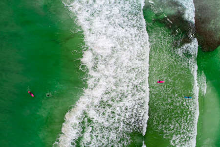 Surfers in tropical ocean waiting wave. Aerial view made with droneのeditorial素材