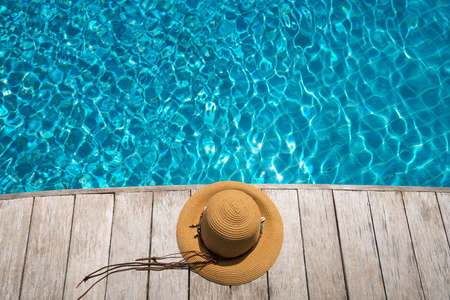 Hat at the side of swimming pool, summer travel conceptの写真素材