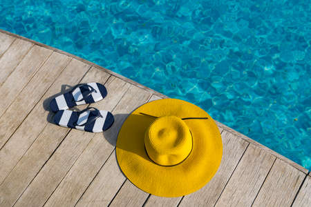 Flip flops  at the side of swimming pool, summer travel concept.の写真素材