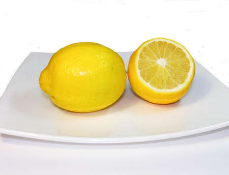 two lemons on a white plateの写真素材