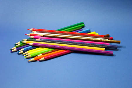 colored pencils ion a blue backgroundの写真素材