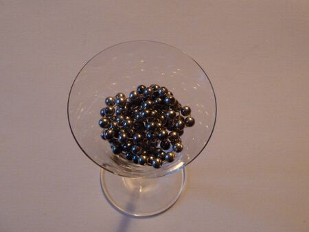 silver black beads in a cocktail glassの写真素材