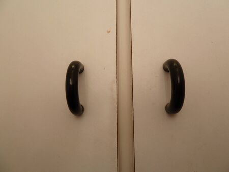 black door handles on white doorsの写真素材