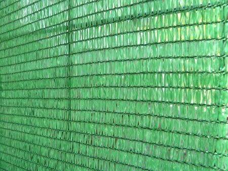 section of a bright green plastic screenの写真素材