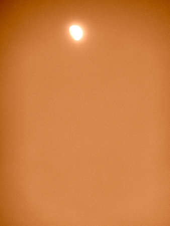 orange sky with the moon as a background