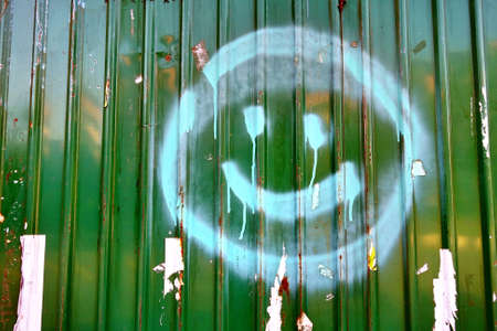 smiling face symbol spray on metal sheetの写真素材