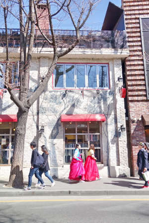 A group of young girls in Korean traditional dress 'Hanbok' are walking along the street of Seoulのeditorial素材