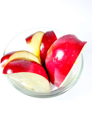 Sliced apple in glass isolated on whiteの写真素材