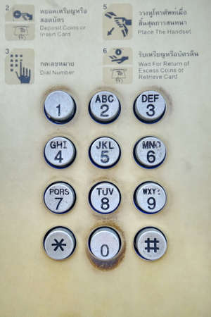 old and dirty pay phone dialの写真素材