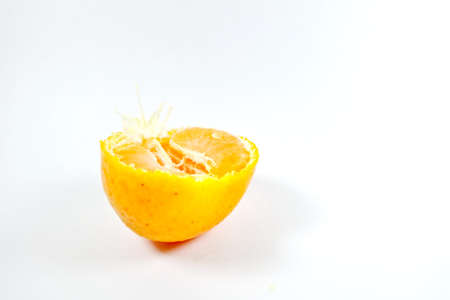 Peeled tangerine or mandarin fruit isolated on white backgroundの写真素材