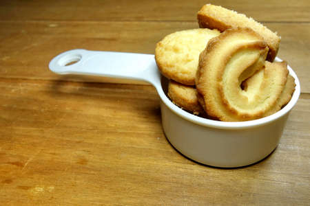 Butter cookies on a wood background.