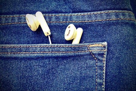 Earphones in jeans's pocket, vintage filter.の写真素材