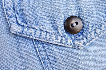 Closeup blue denim with pocket and button.
