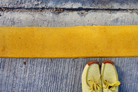 Fashion shoes on concrete floor with yellow strip lineの写真素材