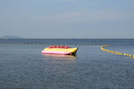 Inflatable banana boat on waterの写真素材
