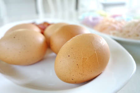 Crack boil egg on white plate, ready to eatの写真素材