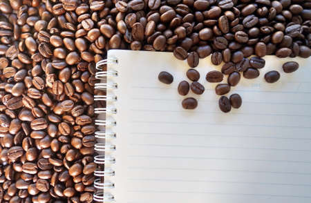 blank notebook with coffee beans background.の写真素材