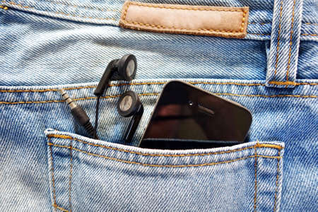 earphone and smartphone in jean pocketの写真素材