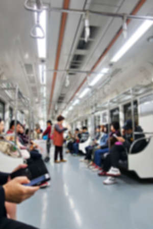 Blurred image of People Sitting and use smart phone on Mass Transit (Sky Train or Subway), Abstract Blur Defocus Background.の写真素材