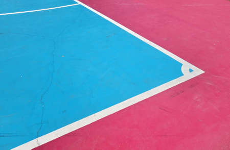 White line on colorful concrete floor of outdoor basketball court.の写真素材