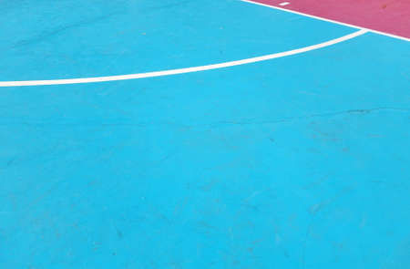 White line on colorful concrete floor of outdoor basketball court.の写真素材