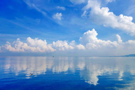 cloudscape ,blue sky with reflection in the sea.の写真素材
