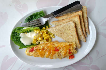 Veggie omelette, healthy breakfast with salad and bread.の写真素材