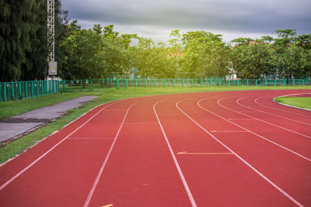 Red running track in stadium,running track on blue sky in the morning