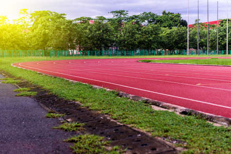 Red running track in stadium,running track on blue sky in the morning