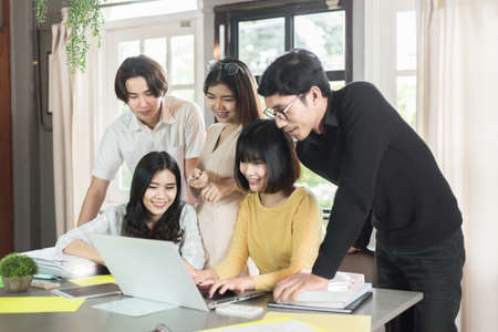 Group of students people sitting together and using laptop in libraryの写真素材