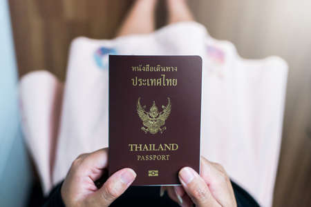 Hand holding Thailand passport,close up