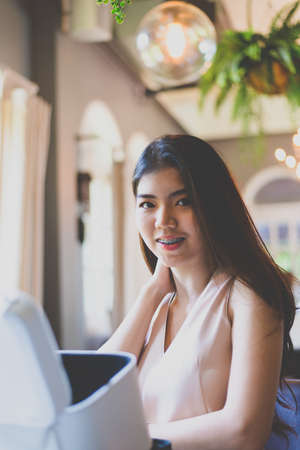 Portrait young Asian pretty business woman smiling and looking camera,close upの写真素材