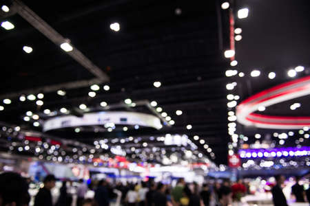 Abstract blurred background image with bokeh light of crowd people background at motor show