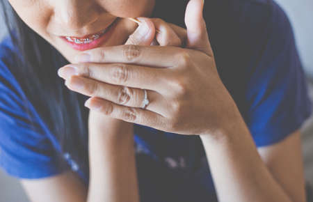 Close up of woman using toothpick