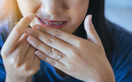 Close up of woman using toothpick